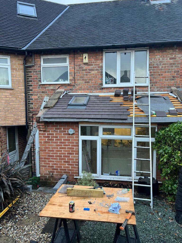 This is a photo of a roof extension that is having new roof tiles installed. This is a photo taken from the roof ridge looking down a tiled pitched roof on to a flat roof. Works carried out by Lee-on-the-Solent  Roofing Repairs