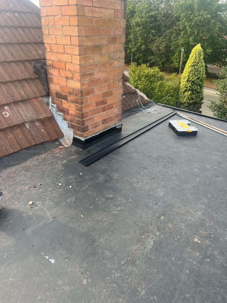 This is a photo of a flat roof which has just been repaired, there is also a chimney stack and some leadwork has also been dressed. Works carried out by Lee-on-the-Solent Roofing Repairs