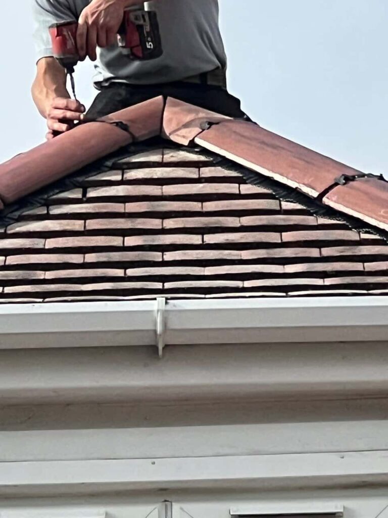 This is a photo of one of the operatives of Lee-on-the-Solent  Roofing Repairs installing new ridge tiles